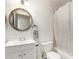 This is a full bathroom with a vanity sink, toilet, round mirror, and a shower at 3144 S Rogers --, Mesa, AZ 85202