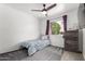 This bedroom has a ceiling fan, carpet, and window to provide natural light at 3144 S Rogers --, Mesa, AZ 85202