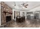 Open concept dining room featuring a stone fireplace and stainless steel appliances at 3144 S Rogers --, Mesa, AZ 85202