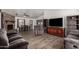 Spacious living room featuring wood flooring, a stone fireplace, and large windows at 3144 S Rogers --, Mesa, AZ 85202