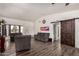 Open concept living room with wood flooring, neutral walls, and barn door at 3144 S Rogers --, Mesa, AZ 85202