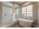Primary bathroom featuring soaking tub and glass enclosed shower with white tile at 3171 S Hawthorn Ct, Gold Canyon, AZ 85118