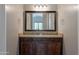 Bathroom vanity with granite countertop, dark wood cabinets, and a large framed mirror at 3171 S Hawthorn Ct, Gold Canyon, AZ 85118