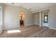 Spacious bedroom with wood floors, neutral walls, and doorway to the bathroom at 3171 S Hawthorn Ct, Gold Canyon, AZ 85118