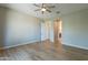 Neutral bedroom design with hardwood floors, ceiling fan, large window, and en-suite access at 3171 S Hawthorn Ct, Gold Canyon, AZ 85118