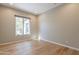 Bright bedroom featuring hardwood floors and a large window for natural light at 3171 S Hawthorn Ct, Gold Canyon, AZ 85118