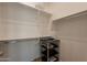 Walk-in closet with white walls, laminate flooring and a shelving unit at 3171 S Hawthorn Ct, Gold Canyon, AZ 85118