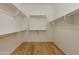 Walk-in closet featuring laminate wood flooring and white shelving at 3171 S Hawthorn Ct, Gold Canyon, AZ 85118