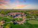 Aerial view of golf course clubhouse and restaurant with sunset sky at 3171 S Hawthorn Ct, Gold Canyon, AZ 85118