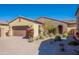 Exterior home with two-car garage, stone accents, desert landscaping and covered entryway at 3171 S Hawthorn Ct, Gold Canyon, AZ 85118