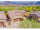 Desert home featuring a stone archway entrance, blooming flowers, and mountain views at 3171 S Hawthorn Ct, Gold Canyon, AZ 85118