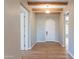Foyer with hardwood floors, exposed wood beam ceiling, and white door at 3171 S Hawthorn Ct, Gold Canyon, AZ 85118