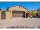 Exterior view of two-car garage with decorative stone driveway, walkway, and desert landscaping at 3171 S Hawthorn Ct, Gold Canyon, AZ 85118