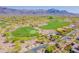 Aerial view of the community golf course and neighborhood with desert landscaping and mountain views at 3171 S Hawthorn Ct, Gold Canyon, AZ 85118