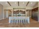 Beautiful kitchen island with granite countertops, wooden cabinets, and stainless steel refrigerator at 3171 S Hawthorn Ct, Gold Canyon, AZ 85118