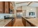 Well-equipped kitchen with stainless appliances, island with sink, granite countertops, and ample cabinet storage at 3171 S Hawthorn Ct, Gold Canyon, AZ 85118