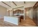 Spacious kitchen features a large island, stainless steel appliances, wooden beams, and hardwood floors at 3171 S Hawthorn Ct, Gold Canyon, AZ 85118
