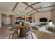 Spacious living room with wooden beams, hardwood floors, and an open floor plan to the kitchen at 3171 S Hawthorn Ct, Gold Canyon, AZ 85118