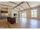 Open-concept kitchen and living room featuring hardwood floors, wood beam ceilings, and lots of light at 3171 S Hawthorn Ct, Gold Canyon, AZ 85118