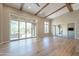 Expansive living room featuring a wood-beam ceiling, beautiful hardwood floors, and multiple windows at 3171 S Hawthorn Ct, Gold Canyon, AZ 85118