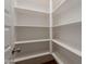 Walk-in pantry with white shelving and laminate flooring at 3171 S Hawthorn Ct, Gold Canyon, AZ 85118