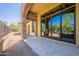 Covered patio with tiled floor and views of the desert landscape and blue sky at 3171 S Hawthorn Ct, Gold Canyon, AZ 85118