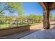 Covered patio with stone accents and views of the landscaped backyard and mountains at 3171 S Hawthorn Ct, Gold Canyon, AZ 85118