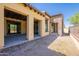 Back of the house with a covered patio and stucco and brick exterior at 3171 S Hawthorn Ct, Gold Canyon, AZ 85118