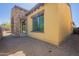 Rear view of a house with stucco and stone accents and a covered patio at 3171 S Hawthorn Ct, Gold Canyon, AZ 85118