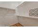 Walk-in closet with white walls, shelves, and wooden floors at 3171 S Hawthorn Ct, Gold Canyon, AZ 85118