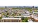 Expansive aerial view of an apartment complex with desert landscaping and skyline views of Phoenix in the background at 349 E Thomas Rd # E401, Phoenix, AZ 85012
