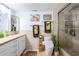 Bright bathroom featuring a walk-in shower, travertine tile, and modern fixtures at 349 E Thomas Rd # E401, Phoenix, AZ 85012