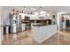 Well-lit kitchen with white cabinets, stainless steel appliances, and travertine tile floors at 349 E Thomas Rd # E401, Phoenix, AZ 85012