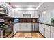 This kitchen features white cabinets, brown countertops, and travertine tile flooring at 349 E Thomas Rd # E401, Phoenix, AZ 85012