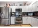 Bright kitchen featuring white cabinets, stainless steel appliances, and breakfast bar at 349 E Thomas Rd # E401, Phoenix, AZ 85012