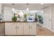Kitchen with breakfast bar, white cabinets, and views of the dining area and outdoor scenery at 349 E Thomas Rd # E401, Phoenix, AZ 85012