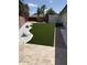 Backyard with fresh green artificial grass, white gravel, and clean landscaping at 3758 E Sunnyside Dr, Phoenix, AZ 85028