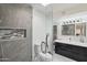 Modern bathroom featuring a glass shower, stylish tile work, and sleek vanity with dual sinks at 3758 E Sunnyside Dr, Phoenix, AZ 85028