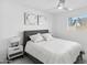 Well-lit bedroom featuring a cozy bed, contemporary artwork, and a bright window view at 3758 E Sunnyside Dr, Phoenix, AZ 85028