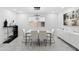 Bright dining room with a modern table set, sleek sideboard, and contemporary lighting at 3758 E Sunnyside Dr, Phoenix, AZ 85028