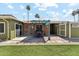 Private backyard with an outdoor seating area, artificial grass, a brick patio, and mature palm trees at 4008 W Citrus Way, Phoenix, AZ 85019
