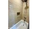 Clean bathroom showing neutral tiled walls, a hand held shower head, and grab bar at 4008 W Citrus Way, Phoenix, AZ 85019