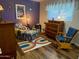 Colorful bedroom with a cozy sitting area, vintage furniture, and bright decor at 4008 W Citrus Way, Phoenix, AZ 85019