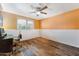 Bright bedroom with a ceiling fan, desk, and wood-look flooring at 4008 W Citrus Way, Phoenix, AZ 85019