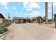 Spacious driveway leading to a two-car garage and quaint home with a brick accent at 4008 W Citrus Way, Phoenix, AZ 85019