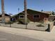 Charming single-story home with a mix of brick and siding, complemented by a decorative black metal fence at 4008 W Citrus Way, Phoenix, AZ 85019