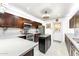 Modern kitchen with stainless steel appliances, white tile backsplash, quartz countertops, and a functional island at 4008 W Citrus Way, Phoenix, AZ 85019