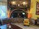 Warm living room showcasing a unique brick fireplace and comfortable yellow chair at 4008 W Citrus Way, Phoenix, AZ 85019