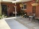 Charming brick patio featuring hanging flower baskets and a cozy seating area at 4008 W Citrus Way, Phoenix, AZ 85019
