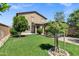 Manicured backyard featuring grass, stone and wood accents, and a pergola at 41311 W Elm Dr, Maricopa, AZ 85138